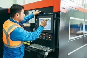 Worker operating CNC machine center